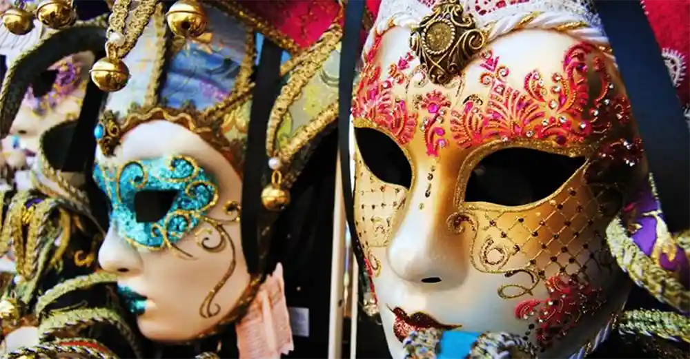 Primi piani di maschere veneziane decorate con perline, glitter e ricami colorati, tipiche del Carnevale