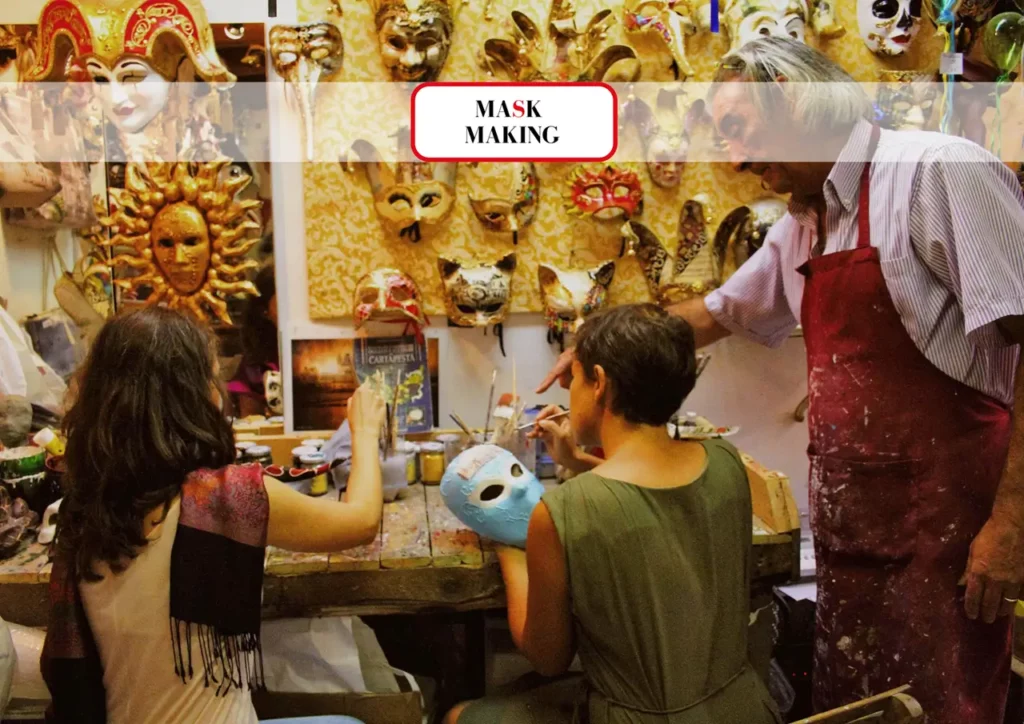 Artisan teaching people Venetian mask decoration
