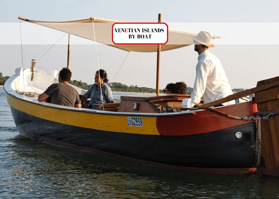 Traditional wooden boat sailing in the Venetian Lagoon with tourists enjoying a guided tour of the islands.