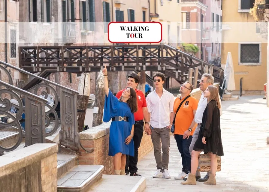 Group of visitors on a guided walking tour in Venice, admiring historic bridges and canals